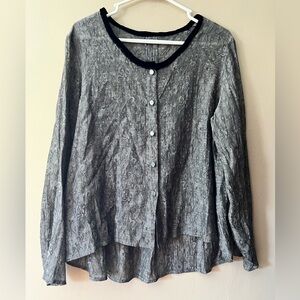 Grey semi sheer textured button up blouse with long sleeves and high low style.